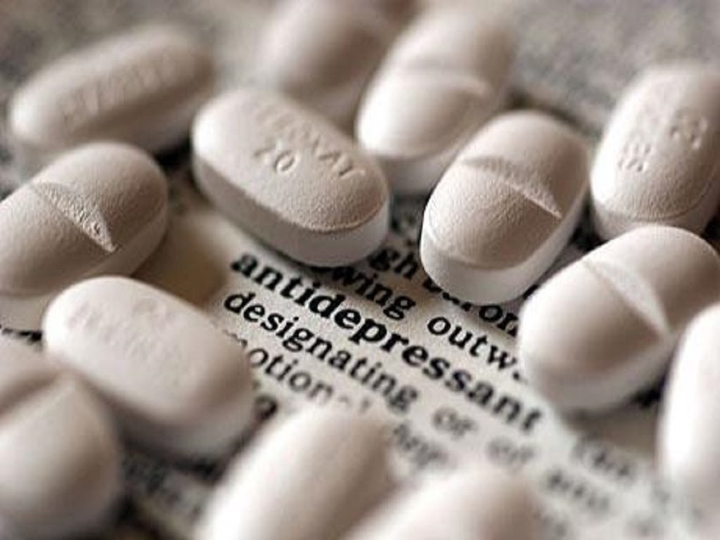 Горсть антидепрессантов в таблетках на газете