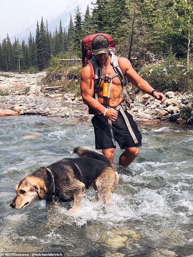 Adventuring: Michael and BearBear wade through a river in the Canadian wilderness near their home in Alberta. The daring duo are happiest when their exploring the outdoors