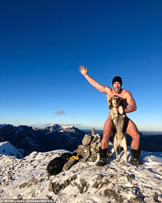 On top of the world: Michael Dietrich, 28, of Edmonton, Canada, spends half his week hiking up mountains, wading through rivers and camping in the wild, all with his trusted dog BearBear by his side. Pictured, the pair pose for an outrageous photo on top of a mountain